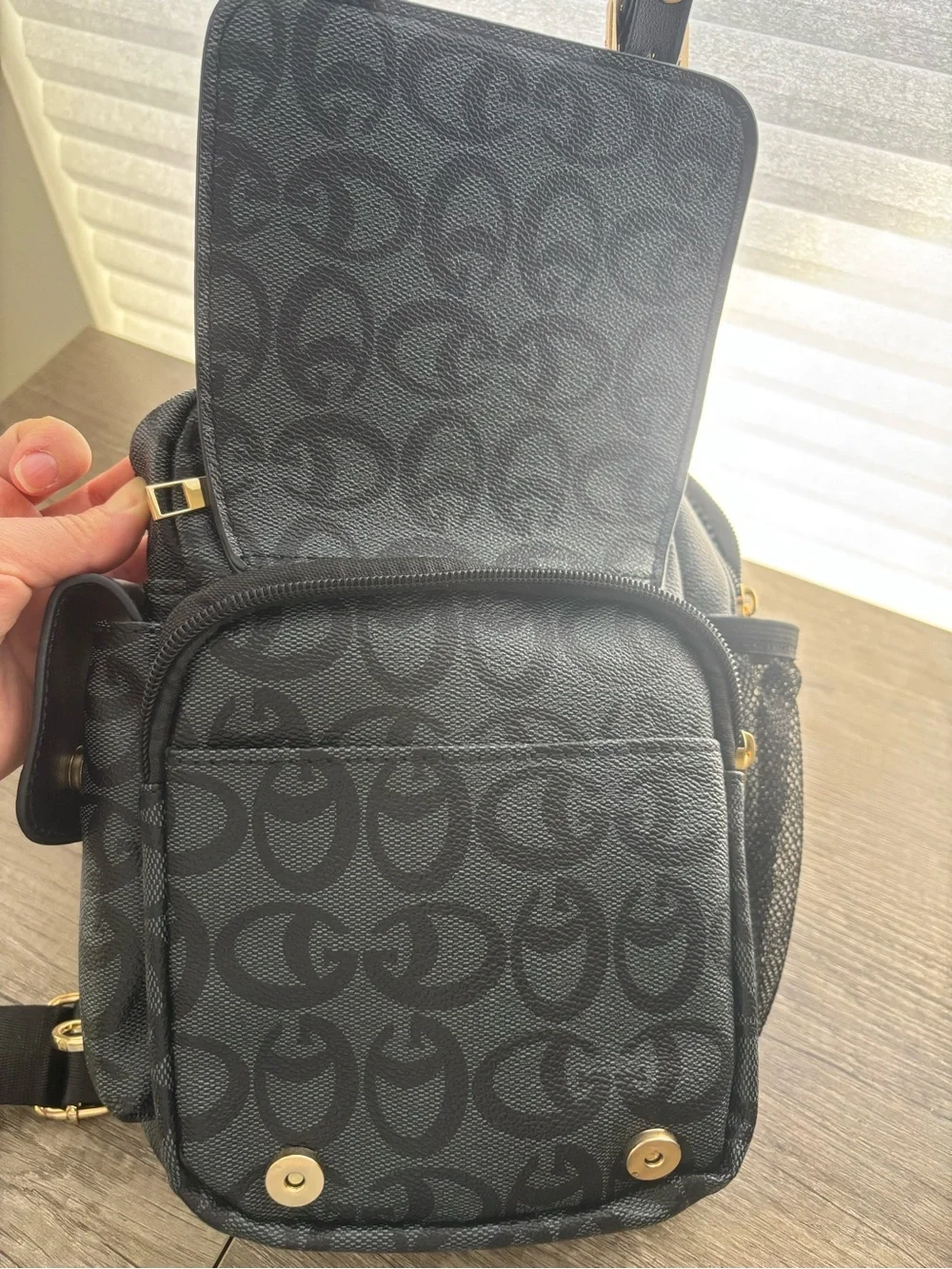 Black Sling Backpack with Signature Pattern